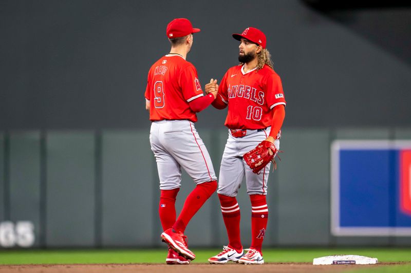 Sep 9, 2024; Minneapolis, Minnesota, USA; Los Angeles Angels shortstop Zach Neto (9) and shortstop Jack Lopez (10) celebrate after defeating the Minnesota Twins at Target Field. Mandatory Credit: Jesse Johnson-Imagn Images