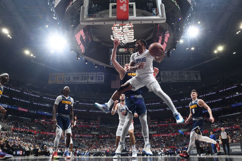 LOS ANGELES, CA - APRIL 4: Norman Powell #24 of the LA Clippers drives to the basket during the game against the Denver Nuggets on April 4, 2024 at Crypto.Com Arena in Los Angeles, California. NOTE TO USER: User expressly acknowledges and agrees that, by downloading and/or using this Photograph, user is consenting to the terms and conditions of the Getty Images License Agreement. Mandatory Copyright Notice: Copyright 2024 NBAE (Photo by Adam Pantozzi/NBAE via Getty Images)