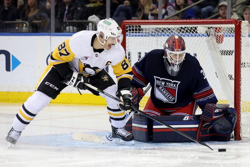 Dec 6, 2024; New York, New York, USA; Pittsburgh Penguins center Sidney Crosby (87) plays the puck in front of New York Rangers goaltender Igor Shesterkin (31) during the second period at Madison Square Garden. Mandatory Credit: Brad Penner-Imagn Images