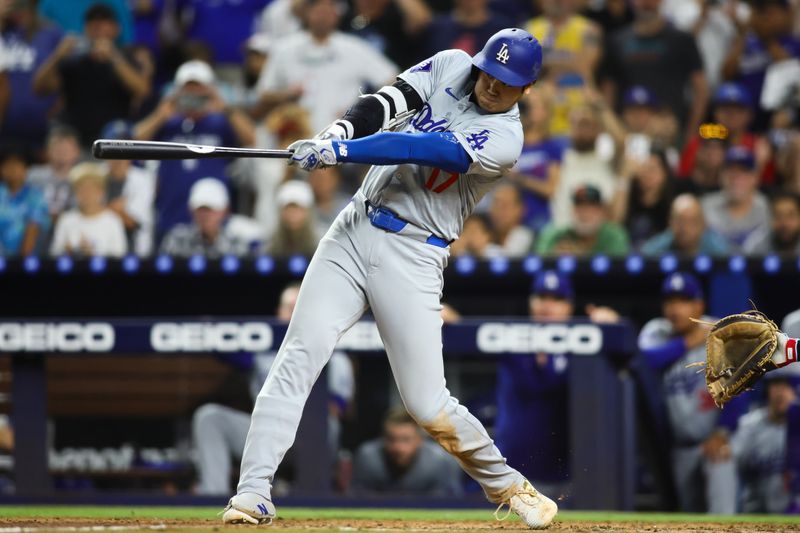 Sep 19, 2024; Miami, Florida, USA; Los Angeles Dodgers designated hitter Shohei Ohtani (17) hits a two-run home run against the Miami Marlins during the seventh inning at loanDepot Park. Mandatory Credit: Sam Navarro-Imagn Images