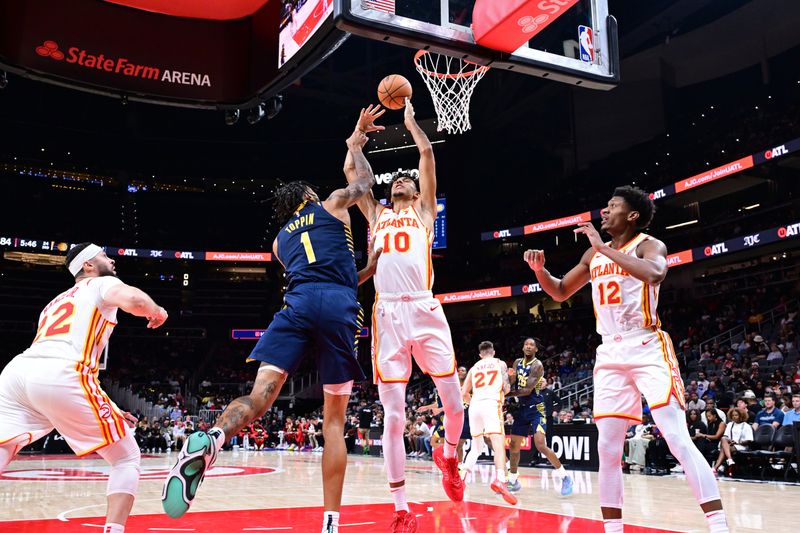 ATLANTA, GA - OCTOBER 8: Zaccharie Risacher #10 of the Atlanta Hawks drives to the basket during the game against the Indiana Pacers during a NBA preseason game on October 8, 2024 at State Farm Arena in Atlanta, Georgia.  NOTE TO USER: User expressly acknowledges and agrees that, by downloading and/or using this Photograph, user is consenting to the terms and conditions of the Getty Images License Agreement. Mandatory Copyright Notice: Copyright 2024 NBAE (Photo by Adam Hagy/NBAE via Getty Images)