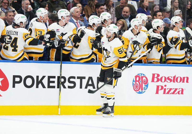 Oct 12, 2024; Toronto, Ontario, CAN; Pittsburgh Penguins defenseman Kris Letang (58) celebrates at the bench after scoring a goal against the Toronto Maple Leafs during the first period at Scotiabank Arena. Mandatory Credit: Nick Turchiaro-Imagn Images