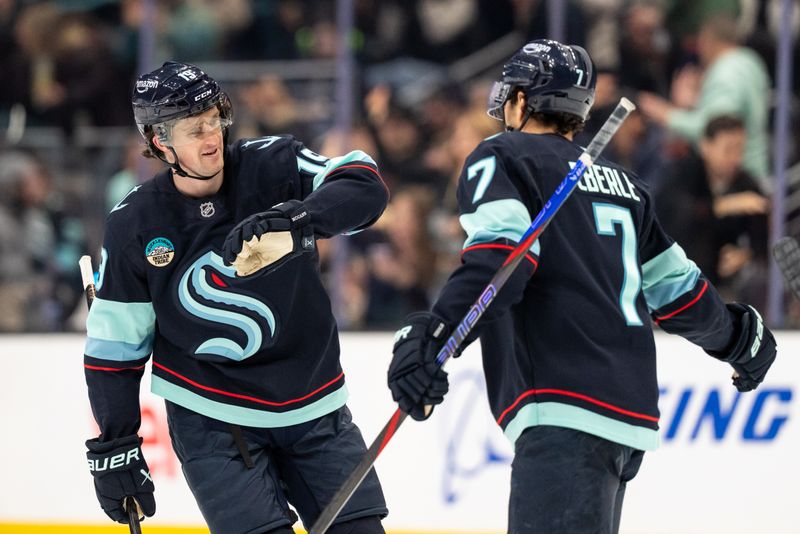 Jan 29, 2026; Seattle, Washington, USA; Seattle Kraken forward Jared McCann (19) celebrates with Seattle Kraken forward Jordan Eberle (7) after scoring a goal during the third period against the Toronto Maple Leafs at Climate Pledge Arena. Mandatory Credit: Stephen Brashear-Imagn Images