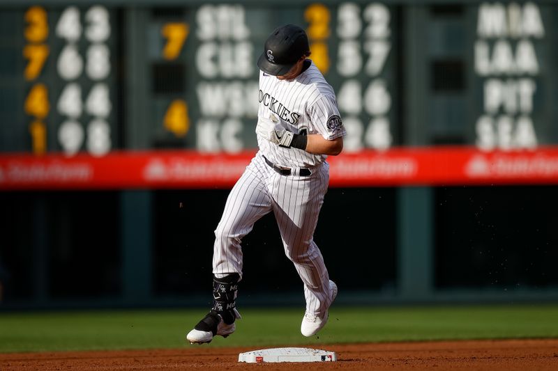 May 26, 2023; Denver, Colorado, USA; Colorado Rockies third baseman Ryan McMahon (24) rounds the bases on a solo home run in the second inning against the New York Mets at Coors Field. Mandatory Credit: Isaiah J. Downing-USA TODAY Sports