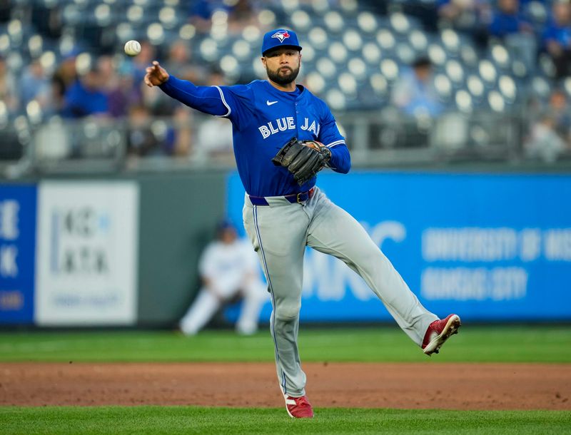 Apr 23, 2024; Kansas City, Missouri, USA; Toronto Blue Jays third base Isiah Kiner-Falefa (7) throws to first base during the third inning against the Kansas City Royals at Kauffman Stadium. Mandatory Credit: Jay Biggerstaff-USA TODAY Sports