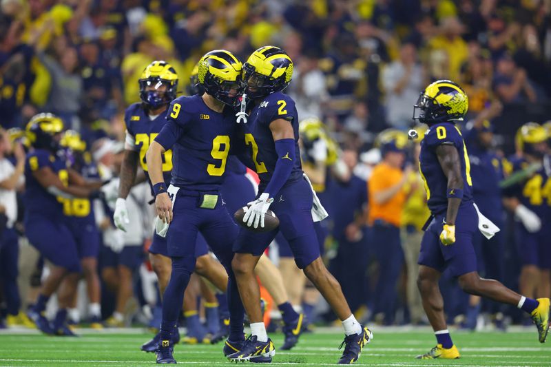 Jan 8, 2024; Houston, TX, USA; Michigan Wolverines defensive back Will Johnson (2) celebrates with quarterback J.J. McCarthy (9) after a turnover against the Washington Huskies during the third quarter in the 2024 College Football Playoff national championship game at NRG Stadium. Mandatory Credit: Mark J. Rebilas-USA TODAY Sports