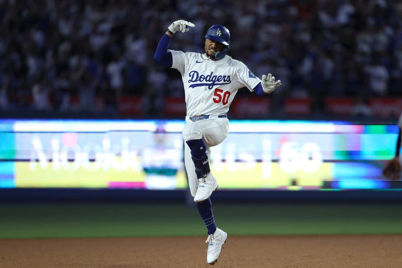 Sep 19, 2025; Los Angeles, California, USA;  Los Angeles Dodgers shortstop Mookie Betts (50) reacts after hitting a solo home run during the fifth inning against the San Francisco Giants at Dodger Stadium. Mandatory Credit: Kiyoshi Mio-Imagn Images