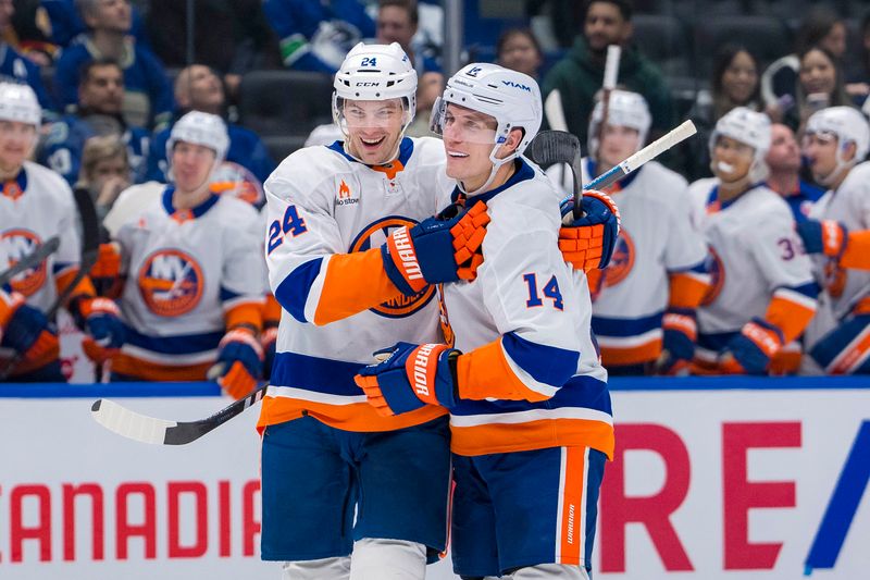 Nov 14, 2024; Vancouver, British Columbia, CAN; New York Islanders defenseman Scott Mayfield (24) and forward Bo Horvat (14) celebrate Mayfield’s goal against the Vancouver Canucks during the second period at Rogers Arena. Mandatory Credit: Bob Frid-Imagn Images