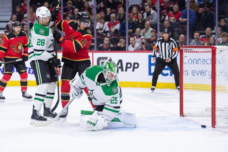 Nov 11, 2025; Ottawa, Ontario, CAN; An  errant puck hits the post after getting past Dallas Stars goalie Jake Oettinger (29) as defenseman Alexander Petrovic (28) and Ottawa Senators center Shane Pinto (12) look on in the first period at the Canadian Tire Centre. Mandatory Credit: Marc DesRosiers-IMAGN Images