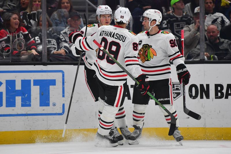 Apr 18, 2024; Los Angeles, California, USA; Chicago Blackhawks left wing Lukas Reichel (27) celebrates his goal scored against the Los Angeles Kings with center Andreas Athanasiou (89) and center Tyler Johnson (90) during the first period at Crypto.com Arena. Mandatory Credit: Gary A. Vasquez-USA TODAY Sports