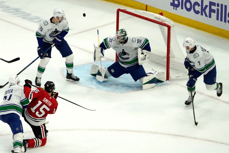 Oct 22, 2024; Chicago, Illinois, USA; Vancouver Canucks goaltender Kevin Lankinen (32) makes a save on Chicago Blackhawks center Craig Smith (15) during the second period at United Center. Mandatory Credit: David Banks-Imagn Images