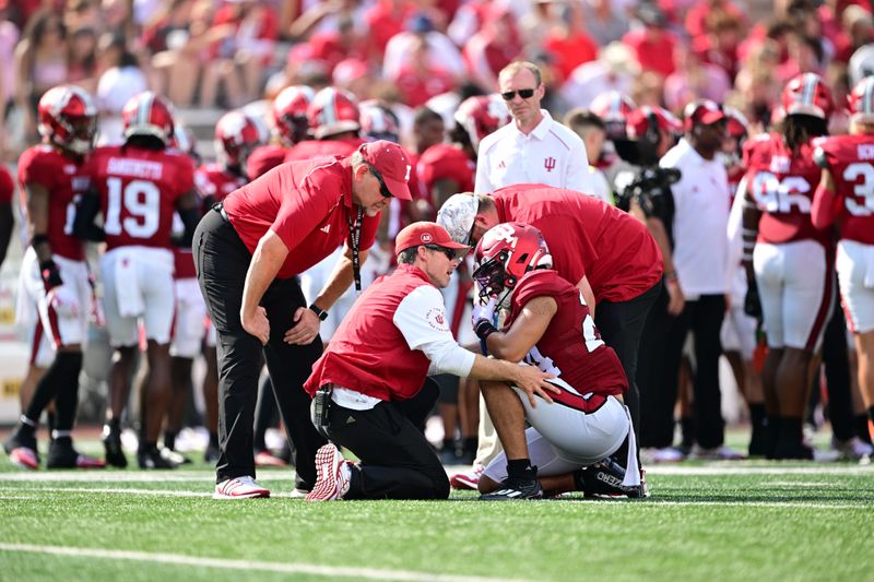 Sep 2, 2023; Bloomington, Indiana, USA; Indiana Hoosiers defensive back Bryson Bonds (24) talks with trainers after taking a hard hit during the second quarter against the Ohio State Buckeyes at Memorial Stadium. Mandatory Credit: Marc Lebryk-USA TODAY Sports