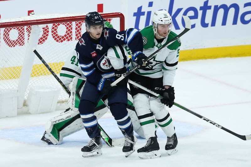 Nov 11, 2023; Winnipeg, Manitoba, CAN;  Dallas Stars defenseman Thomas Harley (55) jostles for position with Winnipeg Jets forward Cole Perfetti (91) during the third period at Canada Life Centre. Mandatory Credit: Terrence Lee-USA TODAY Sports