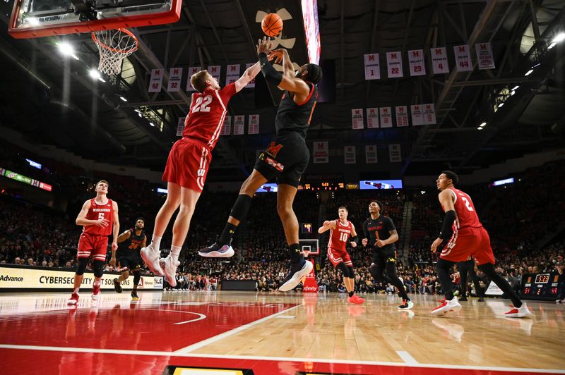 Jan 25, 2023; College Park, Maryland, USA;  Maryland Terrapins guard Don Carey (0) shoots as Wisconsin Badgers forward Steven Crowl (22) defends during the second half at Xfinity Center. Mandatory Credit: Tommy Gilligan-USA TODAY Sports