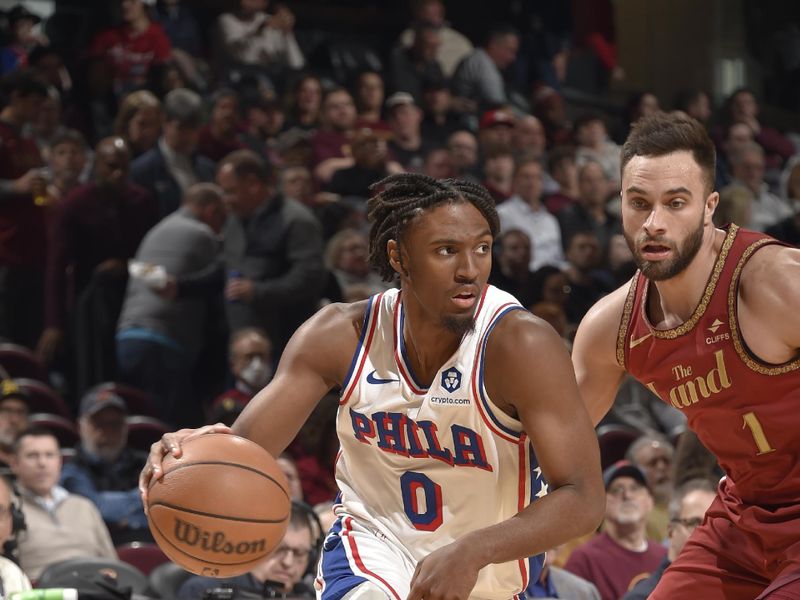 CLEVELAND, OH - FEBRUARY 12: Tyrese Maxey #0 of the Philadelphia 76ers handles the ball against Max Strus #1 of the Cleveland Cavaliers during the game on February 12, 2024 at Rocket Mortgage FieldHouse in Cleveland, Ohio. NOTE TO USER: User expressly acknowledges and agrees that, by downloading and/or using this Photograph, user is consenting to the terms and conditions of the Getty Images License Agreement. Mandatory Copyright Notice: Copyright 2024 NBAE (Photo by David Liam Kyle/NBAE via Getty Images)