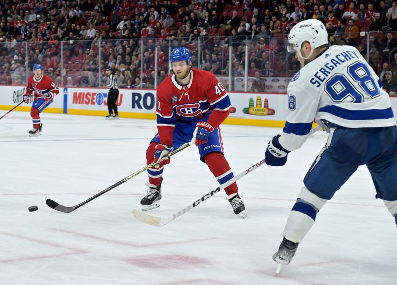 Nov 7, 2023; Montreal, Quebec, CAN; Tampa Bay Lightning defenseman Mikhail Sergachev (98) clears teh puck by Montreal Canadiens forward Joel Armia (40) during the third period at the Bell Centre. Mandatory Credit: Eric Bolte-USA TODAY Sports