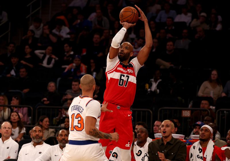 NEW YORK, NEW YORK - OCTOBER 18: Taj Gibson #67 of the Washington Wizards shoots a three point shot over Evan Fournier #13 of the New York Knicks during a preseason game at Madison Square Garden on October 18, 2023 in New York City. NOTE TO USER: User expressly acknowledges and agrees that, by downloading and or using this photograph, User is consenting to the terms and conditions of the Getty Images License Agreement. (Photo by Elsa/Getty Images)