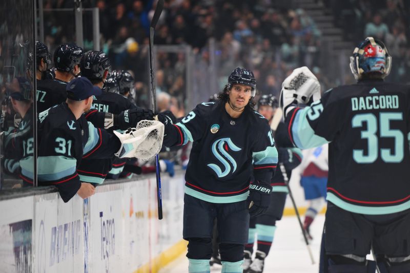 Nov 13, 2023; Seattle, Washington, USA; Seattle Kraken left wing Brandon Tanev (13) celebrates with teammates after scoring a goal against the Colorado Avalanche during the first period at Climate Pledge Arena. Mandatory Credit: Steven Bisig-USA TODAY Sports