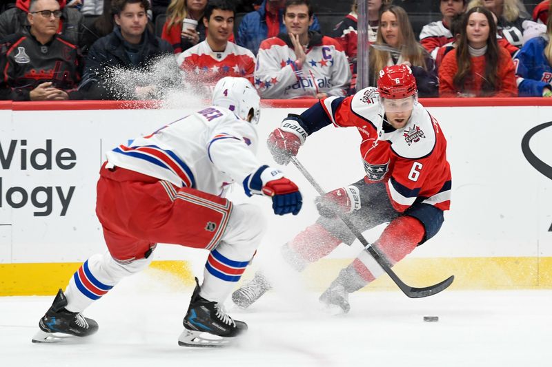 Dec 31, 2025; Washington, District of Columbia, USA; Washington Capitals defenseman Jakob Chychrun (6) controls the puck defended by New York Rangers defenseman Braden Schneider (4) during the first period at Capital One Arena. Mandatory Credit: Hannah Foslien-Imagn Images