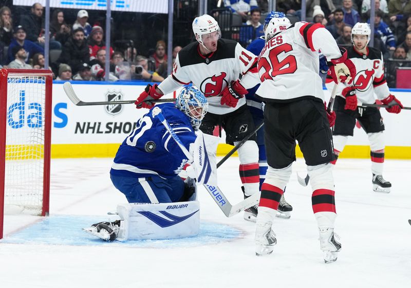 Dec 30, 2025; Toronto, Ontario, CAN; New Jersey Devils right wing Stefan Noesen (11) battles for the puck in front of Toronto Maple Leafs goaltender Joseph Woll (60) during the second period at Scotiabank Arena. Mandatory Credit: Nick Turchiaro-Imagn Images