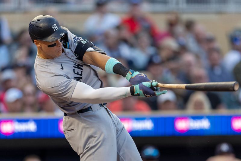 May 14, 2024; Minneapolis, Minnesota, USA; New York Yankees center fielder Aaron Judge (99) hits a single against the Minnesota Twins in the fourth inning  at Target Field. Mandatory Credit: Jesse Johnson-USA TODAY Sports