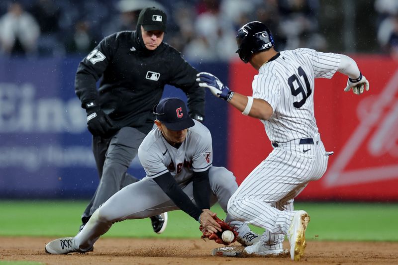 May 3, 2023; Bronx, New York, USA; New York Yankees pinch runner Oswald Peraza (91) is safe a second as the ball gets by Cleveland Guardians second baseman Andres Gimenez (0) during the ninth inning at Yankee Stadium. Mandatory Credit: Brad Penner-USA TODAY Sports