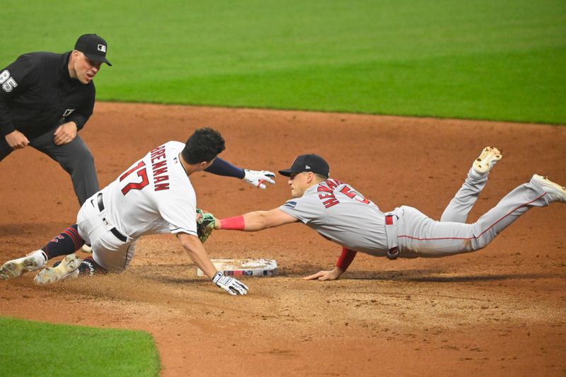 Jun 8, 2023; Cleveland, Ohio, USA; Cleveland Guardians right fielder Will Brennan (17) is tagged out by Boston Red Sox shortstop Enrique Hernandez (5) in the sixth inning at Progressive Field. Mandatory Credit: David Richard-USA TODAY Sports