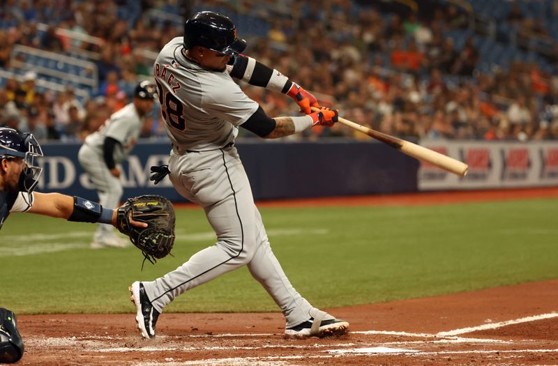 Apr 22, 2024; St. Petersburg, Florida, USA; Detroit Tigers shortstop Javier Báez (28) singles against the Tampa Bay Rays in the second inning at Tropicana Field. Mandatory Credit: Kim Klement Neitzel-USA TODAY Sports