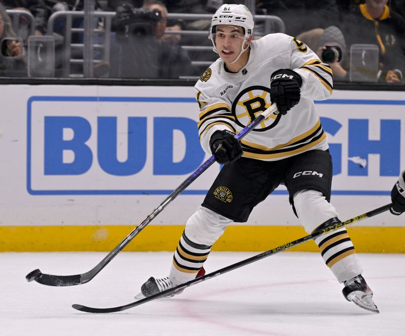 Oct 21, 2023; Los Angeles, California, USA; Boston Bruins center Matthew Poitras (51) takes a shot against the Los Angeles Kings during the third period at Crypto.com Arena. Mandatory Credit: Alex Gallardo-USA TODAY Sports