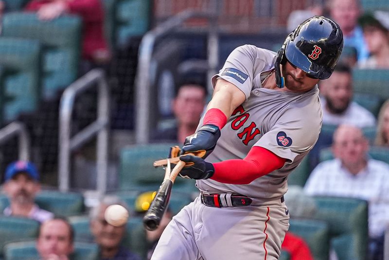 May 7, 2024; Cumberland, Georgia,USA; Boston Red Sox catcher Reese McGuire (3) breaks his bat while hitting a single against the Atlanta Braves during the second inning at Truist Park. Mandatory Credit: Dale Zanine-USA TODAY Sports