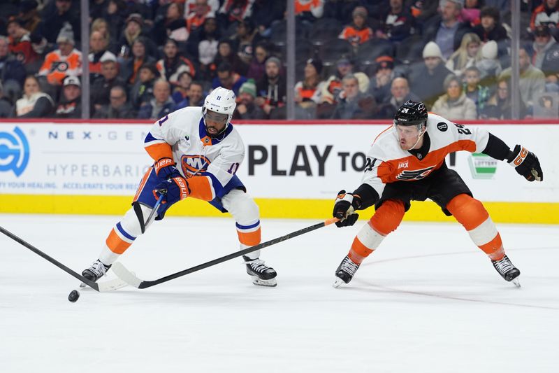Jan 26, 2026; Philadelphia, Pennsylvania, USA; Philadelphia Flyers defenseman Nick Seeler (24) checks the puck from New York Islanders left wing Anthony Duclair (11) in the second period at Xfinity Mobile Arena. Mandatory Credit: Kyle Ross-Imagn Images