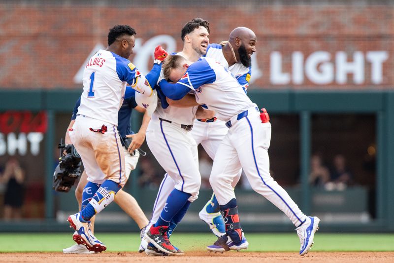 Jun 29, 2024; Cumberland, Georgia, USA; Atlanta Braves second base Ozzie Albies (1), Atlanta Braves bench coach/infield coach Walt Weiss (4), Atlanta Braves designated hitter Marcell Ozuna (20), and Atlanta Braves outfielder Jarred Kelenic (24) celebrate after win against Pittsburgh Pirates at Truist Park. Mandatory Credit: Jordan Godfree-USA TODAY Sports