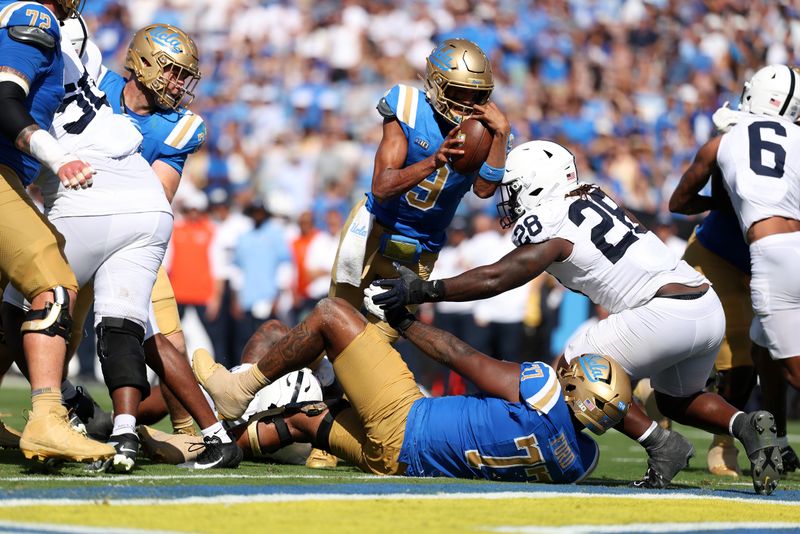 Oct 4, 2025; Pasadena, California, USA;  UCLA Bruins quarterback Nico Iamaleava (9) scores a touchdown on 1 yard run during the third quarter against the Penn State Nittany Lions at Rose Bowl. Mandatory Credit: Kiyoshi Mio-Imagn Images