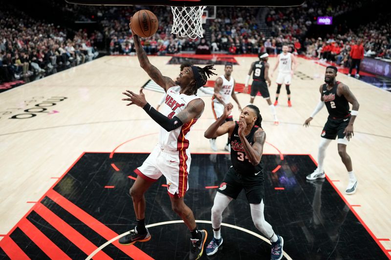 PORTLAND, OREGON - FEBRUARY 27: Delon Wright #4 of the Miami Heat drives to the basket past Jabari Walker #34 of the Portland Trail Blazers during the first half at Moda Center on February 27, 2024 in Portland, Oregon. NOTE TO USER: User expressly acknowledges and agrees that, by downloading and or using this photograph, User is consenting to the terms and conditions of the Getty Images License Agreement. (Photo by Soobum Im/Getty Images)