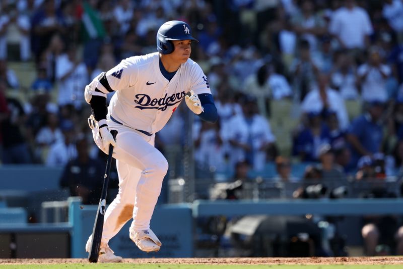 Sep 22, 2024; Los Angeles, California, USA;  Los Angeles Dodgers designated hitter Shohei Ohtani (17) hits a single during the seventh inning against the Colorado Rockies at Dodger Stadium. Mandatory Credit: Kiyoshi Mio-Imagn Images