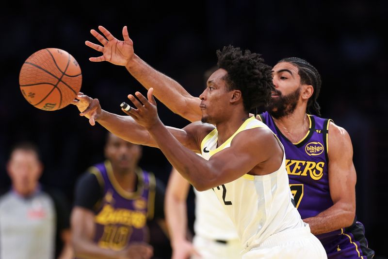 LOS ANGELES, CALIFORNIA - NOVEMBER 19: Collin Sexton #2 of the Utah Jazz reaches for the ball against Gabe Vincent #7 of the Los Angeles Lakers during the second quarter of the Emirates NBA Cup at Crypto.com Arena on November 19, 2024 in Los Angeles, California. NOTE TO USER: User expressly acknowledges and agrees that, by downloading and or using this photograph, User is consenting to the terms and conditions of the Getty Images License Agreement.  (Photo by Harry How/Getty Images)