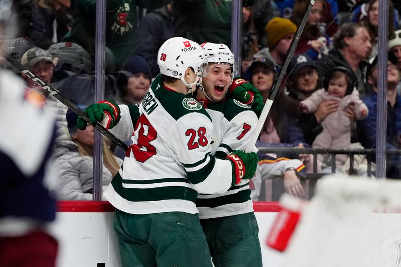 Jan 20, 2025; Denver, Colorado, USA; Minnesota Wild defenseman Brock Faber (7) celebrates his goal with left wing Liam Ohgren (28) in the third period against the Colorado Avalanche at Ball Arena. Mandatory Credit: Ron Chenoy-Imagn Images