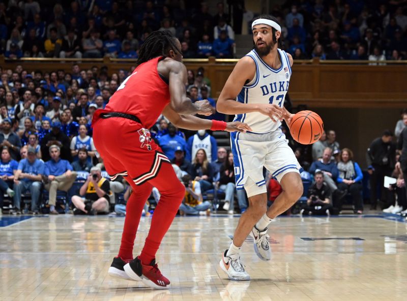 Feb 20, 2023; Durham, North Carolina, USA; Duke Blue Devils guard Jacob Grandison (13) controls the ball in front of Louisville Cardinals guard Mike James (1) during the second half at Cameron Indoor Stadium. The Blue Devils won 79-62. Mandatory Credit: Rob Kinnan-USA TODAY Sports