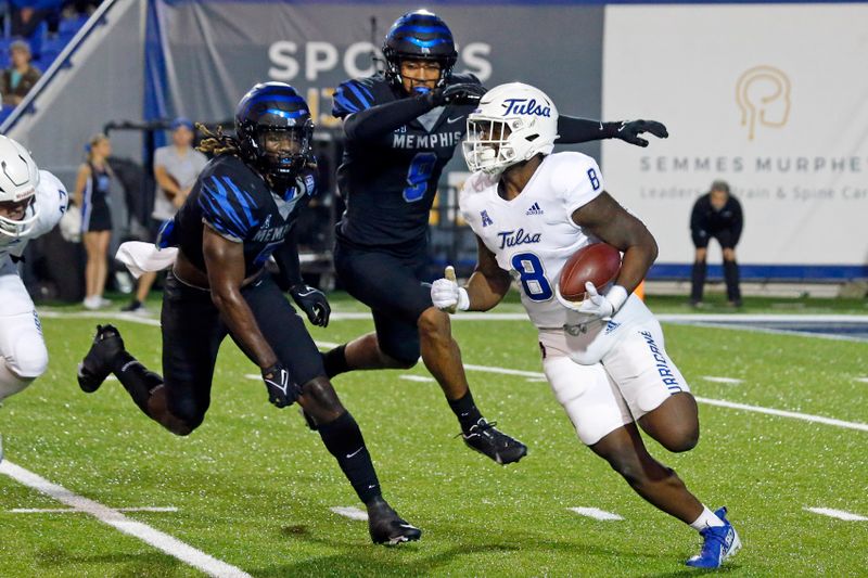 Nov 10, 2022; Memphis, Tennessee, USA; Tulsa Golden Hurricane running back Deneric Prince (8) runs the ball as Memphis Tigers linebackers Tyler Murray (5) and Geoffrey Cantin-Arku pursue him in the back field during the first half at Liberty Bowl Memorial Stadium. Mandatory Credit: Petre Thomas-USA TODAY Sports