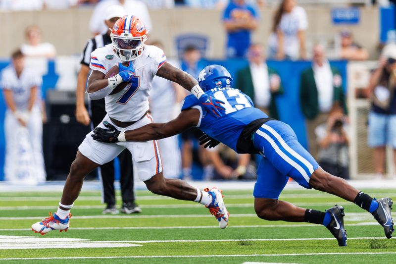 Sep 30, 2023; Lexington, Kentucky, USA; Florida Gators running back Trevor Etienne (7) runs the ball against Kentucky Wildcats linebacker J.J. Weaver (13) during the fourth quarter at Kroger Field. Mandatory Credit: Jordan Prather-USA TODAY Sports