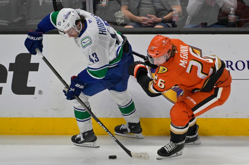 Nov 5, 2024; Anaheim, California, USA;  Vancouver Canucks defenseman Quinn Hughes (43) and Anaheim Ducks defenseman Brian Dumoulin (6) go for the puck in the second period at Honda Center. Mandatory Credit: Jayne Kamin-Oncea-Imagn Images