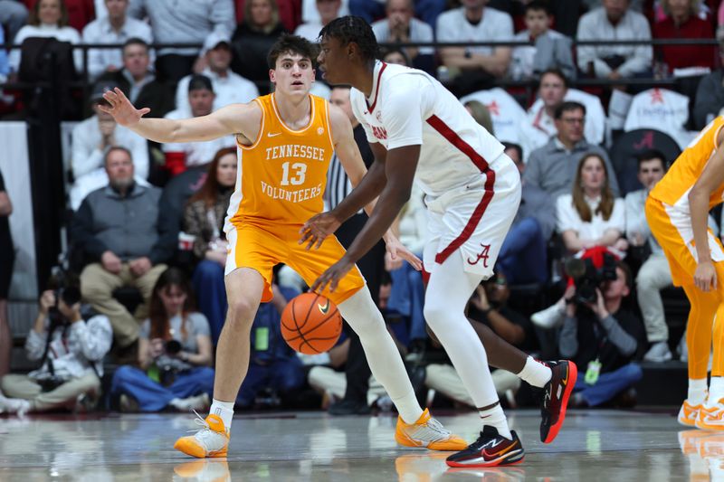 Jan 24, 2026; Tuscaloosa, Alabama, USA; Alabama Crimson Tide forward Aiden Sherrell (22) dribbles against Tennessee Volunteers forward J.P. Estrella (13) during the first half at Coleman Coliseum. Mandatory Credit: David Leong-Imagn Images