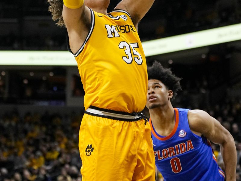 Jan 20, 2024; Columbia, Missouri, USA; Missouri Tigers forward Noah Carter (35) shoots against Florida Gators guard Zyon Pullin (0) during the first half at Mizzou Arena. Mandatory Credit: Jay Biggerstaff-USA TODAY Sports