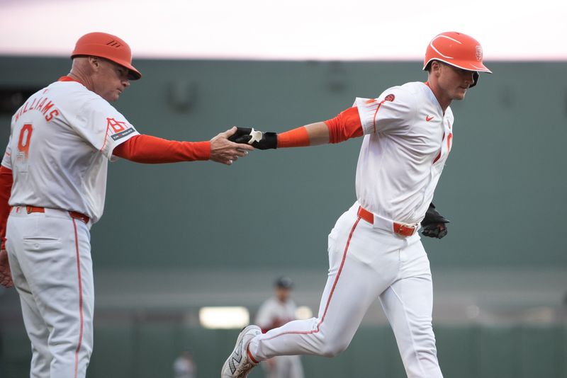 Aug 13, 2024; San Francisco, California, USA;  San Francisco Giants shortstop Tyler Fitzgerald (49) celebrates with third base coach Matt Williams (9) after hitting a home run against the Atlanta Braves during the third inning at Oracle Park. Mandatory Credit: Ed Szczepanski-USA TODAY Sports