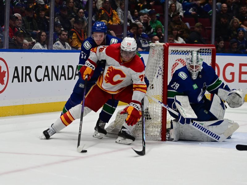 Mar 23, 2024; Vancouver, British Columbia, CAN; Calgary Flames forward Martin Pospisil (76) controls the puck against Vancouver Canucks defenseman Tyler Myers (57) during the third period at Rogers Arena. Mandatory Credit: Simon Fearn-USA TODAY Sports