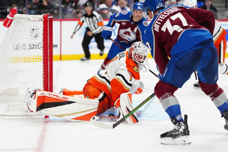 Oct 18, 2024; Denver, Colorado, USA; Anaheim Ducks goaltender Lukas Dostal (1) makes a save on Colorado Avalanche center Casey Mittelstadt (37) in the second period at Ball Arena. Mandatory Credit: Ron Chenoy-Imagn Images