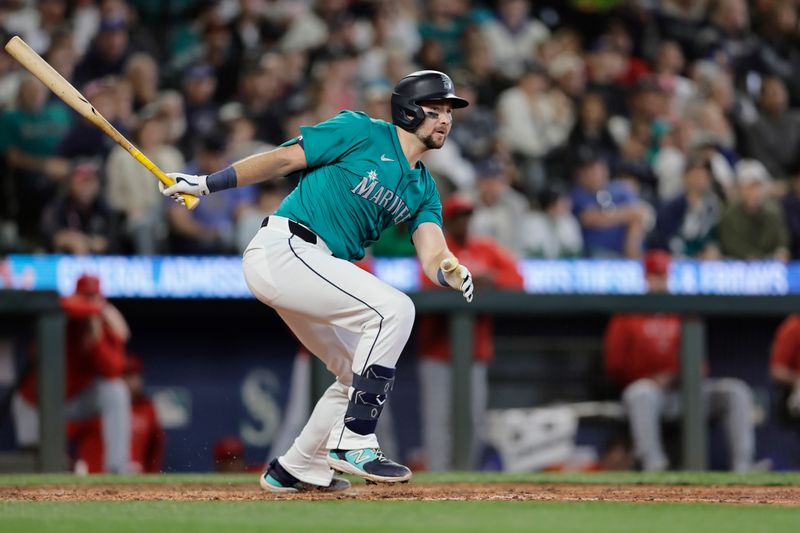 Jun 1, 2024; Seattle, Washington, USA;  Seattle Mariners catcher Cal Raleigh (29) hits a two RBI double against the Los Angeles Angels during the sixth inning at T-Mobile Park. Mandatory Credit: John Froschauer-USA TODAY Sports