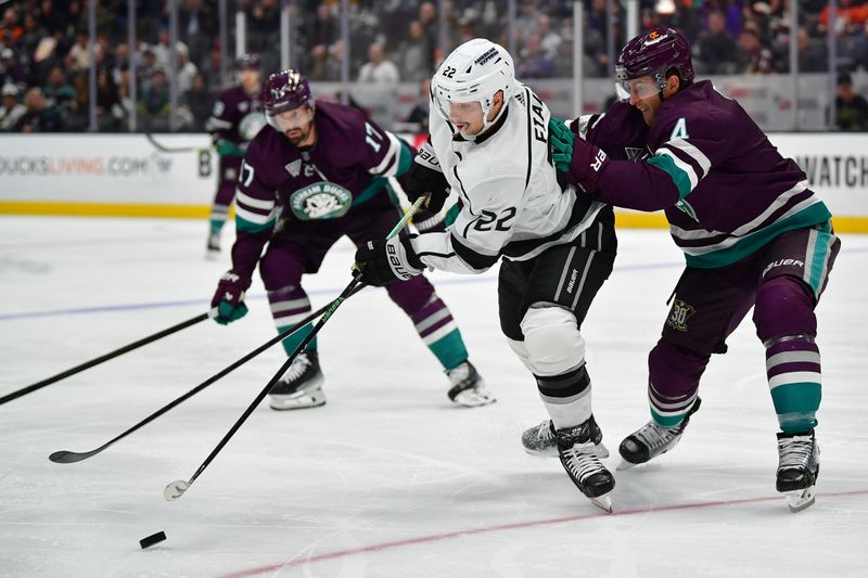 Nov 24, 2023; Anaheim, California, USA; Los Angeles Kings left wing Kevin Fiala (22) plays for the puck against Anaheim Ducks defenseman Cam Fowler (4) during the third period at Honda Center. Mandatory Credit: Gary A. Vasquez-USA TODAY Sports