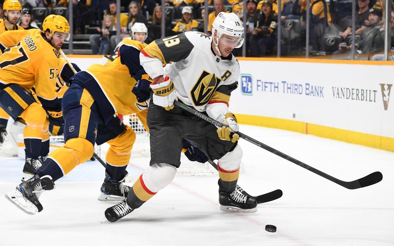 Apr 4, 2023; Nashville, Tennessee, USA; Vegas Golden Knights right wing Reilly Smith (19) handles the puck in the corner during the second period against the Nashville Predators at Bridgestone Arena. Mandatory Credit: Christopher Hanewinckel-USA TODAY Sports