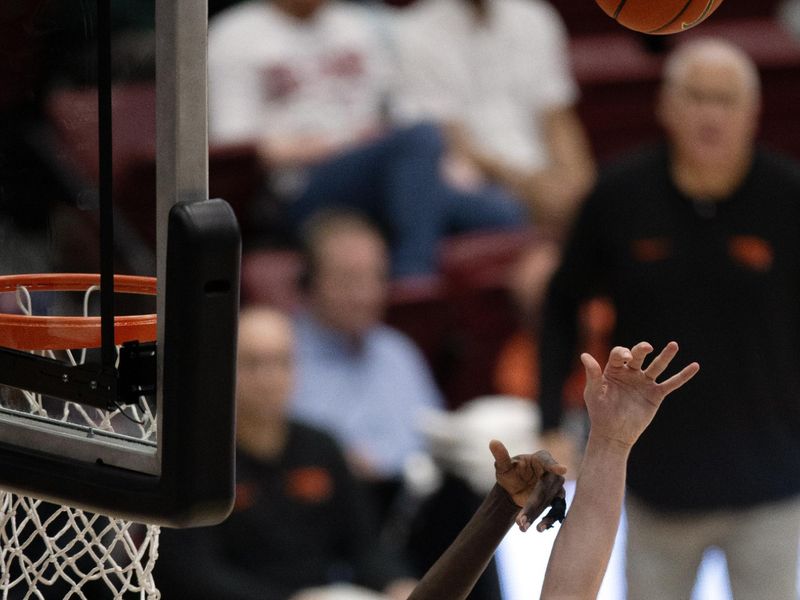 Feb 24, 2024; Stanford, California, USA; Oregon State Beavers center Chol Marial (15) and Stanford Cardinal forward Maxime Raynaud (42) vie for a rebound during the second half at Maples Pavilion. Mandatory Credit: D. Ross Cameron-USA TODAY Sports